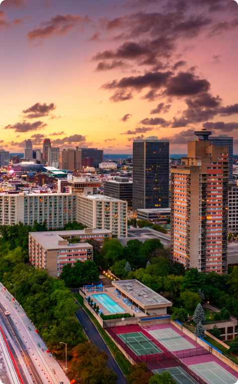 Cityscape at sunset, representing urban roofing needs in Kansas City